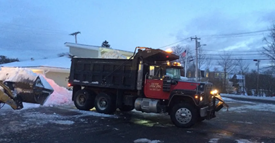 Dump truck fitted with a snow plow